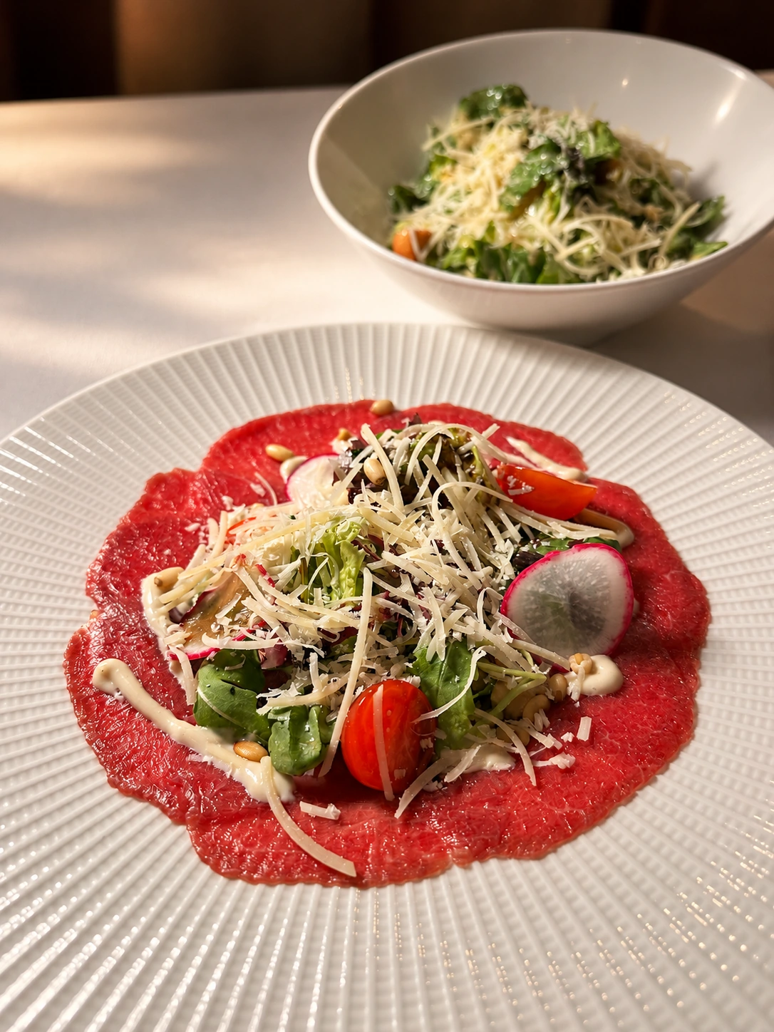 Retouched carpaccio with rich natural color, clean surroundings, and directional light