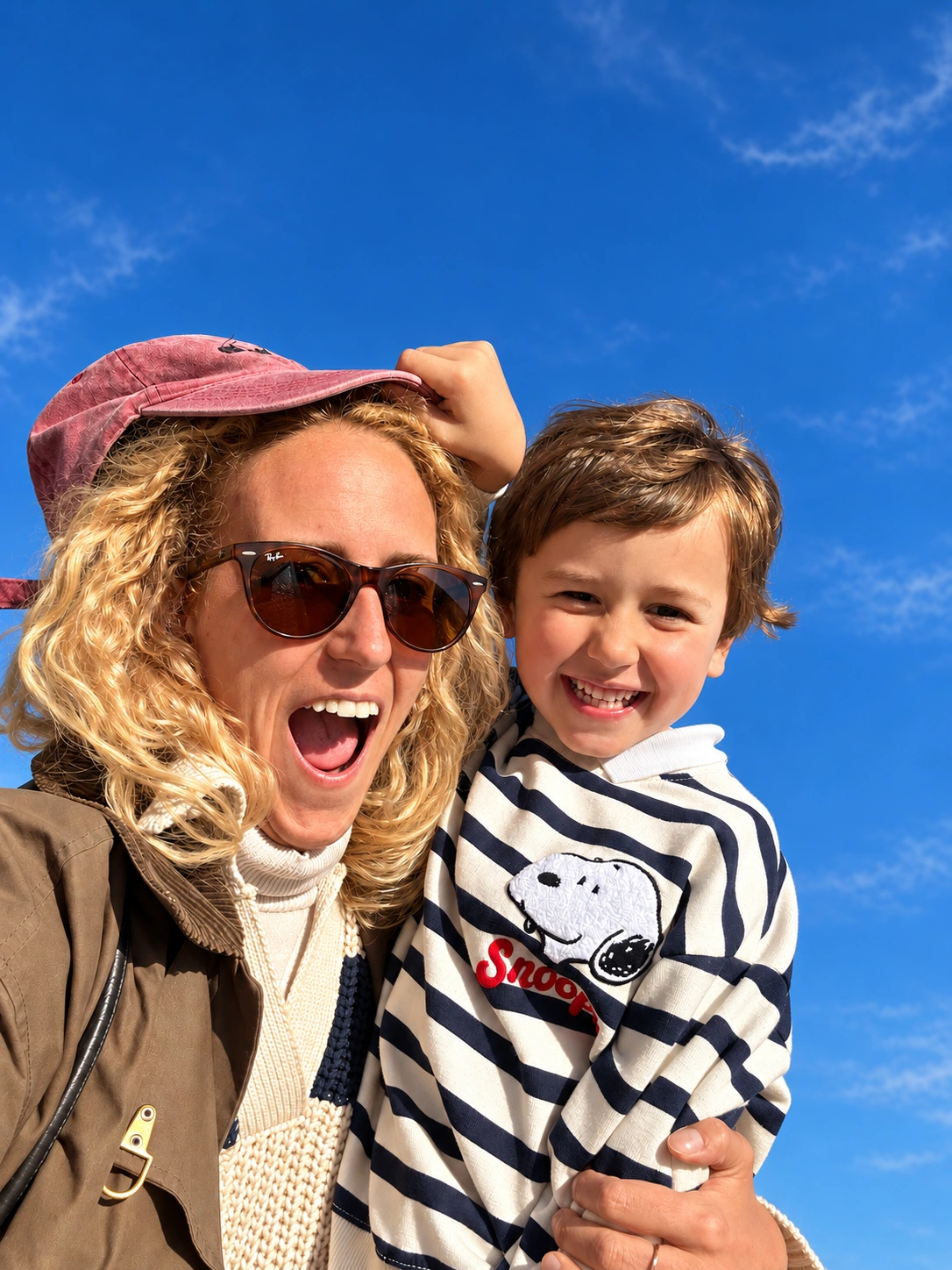 Edited family portrait with polished natural skin, tidied flyaway hair, and balanced facial lighting