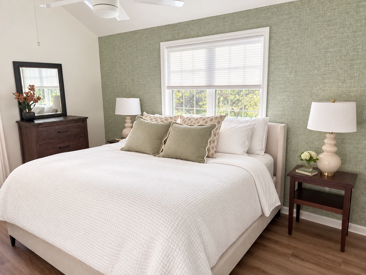 The same bedroom with balanced window light, neatly styled bedding, and restrained bedside decor