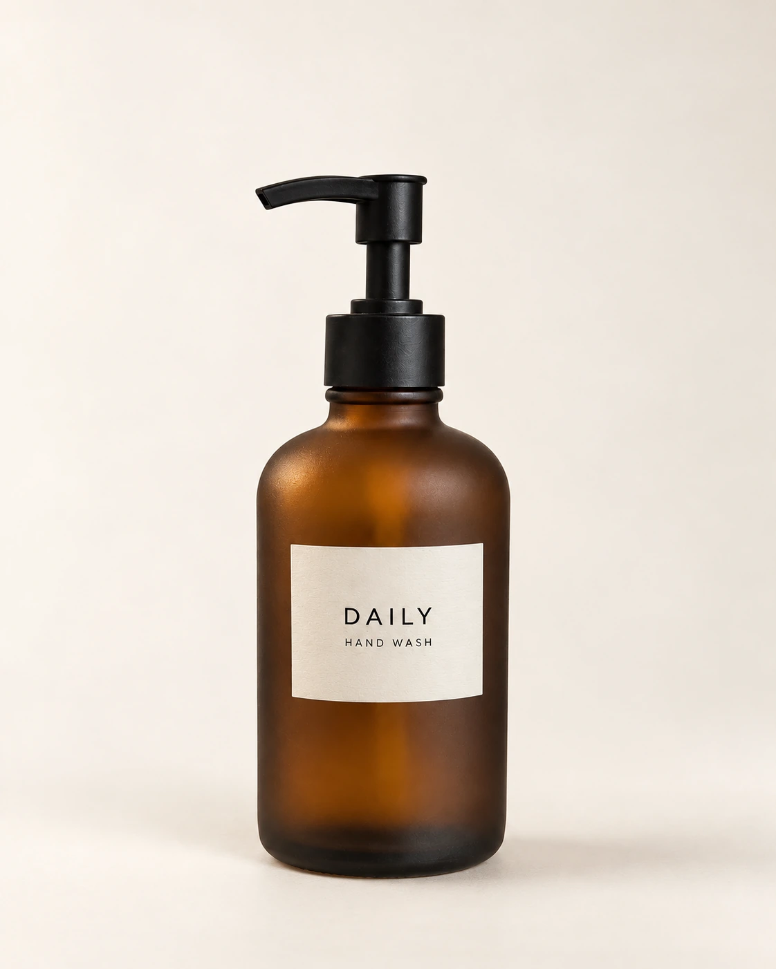 The same hand-wash bottle with clean glass, controlled reflections, and warm studio lighting
